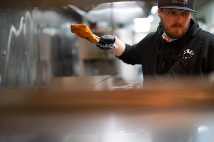 Chef Clayton James works on the lunch menu at Hi Hat.