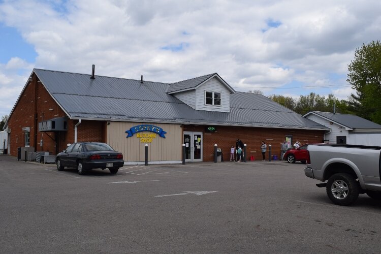 A line of socially-distanced customers stood outside along the length of Copey's Butcher Shop in Medway waiting to buy meat. At times, the line has wrapped around the parking lot.