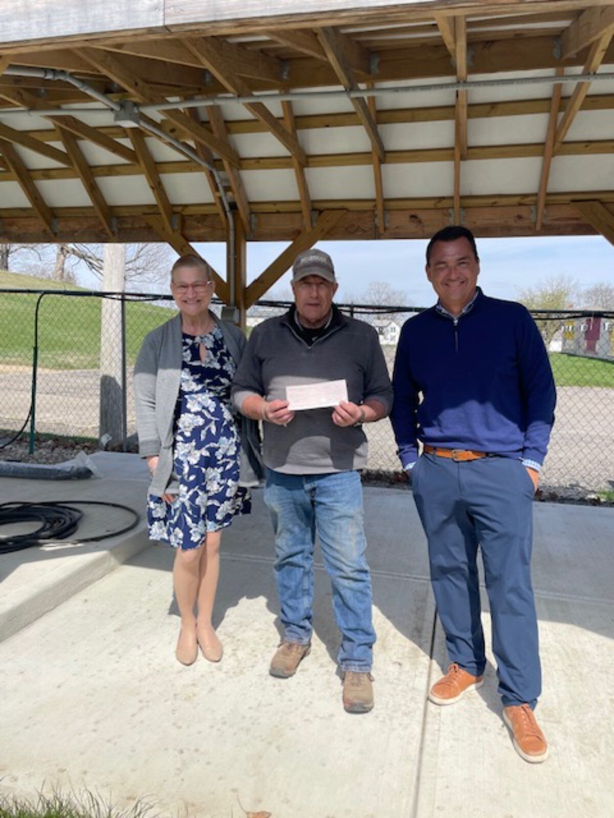 Terry Fredrich accepts a check from tehe Springfield Rotary Club that will help a number of programs at the garden grow.