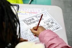 Elementary school students coloring for area Veterans